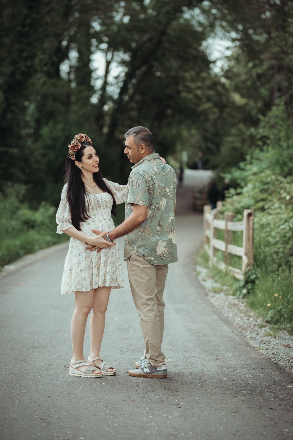 Expecting couple holding hands during a quiet forest maternity session
